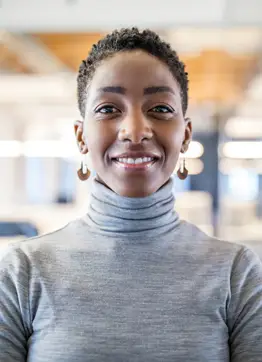 Woman entrepreneur smiles and looks into the camera