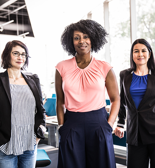 Three business women standing in an office
