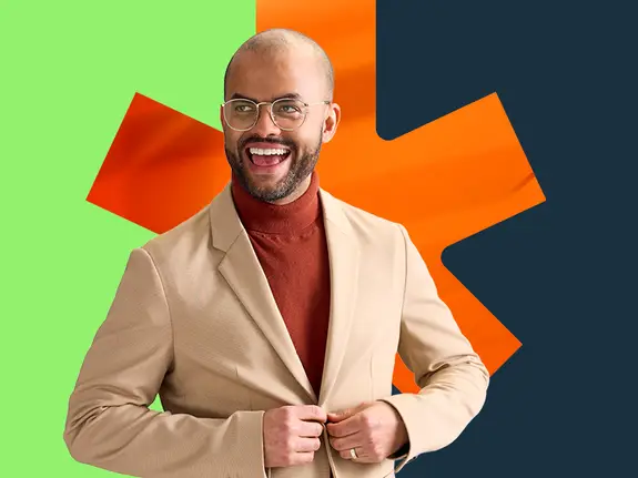 Portrait of a happy employee in a beige jacket on an orange maple leaf