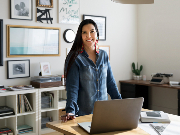 first nations woman smiling in her bright office