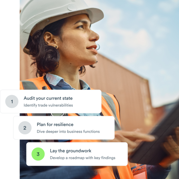 Woman on export site with helmet, tablet and an orange vest