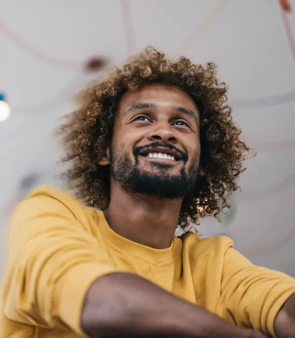 Smiling young man with afro