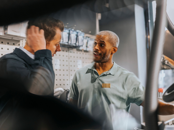 salesman advising customer in a electronics store