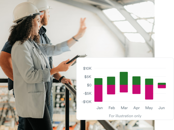 Woman and man with hard hats discussing in a factory